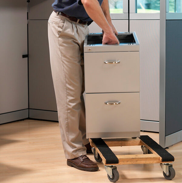 Man moving an office metal file cabinet