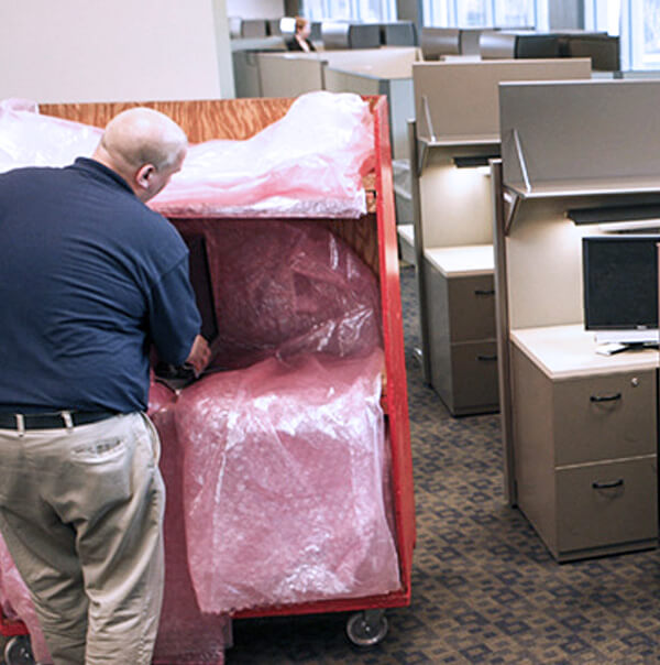 A professional mover moving office workstations
